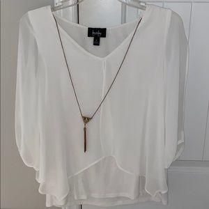 White blouse with gold necklace